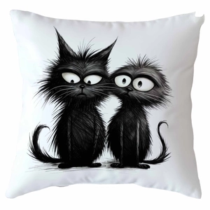 Close-up detail of white square pillow case featuring hand-drawn black cartoon cats