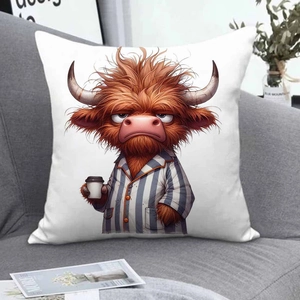Detail of square pillowcase with cute highland cow holding coffee on grey fabric sofa