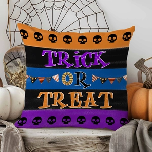 Close-up of Halloween pillow case with Trick or Treat text on a rustic wooden table