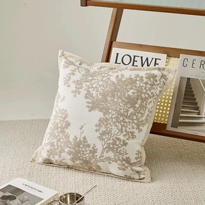 Close-up of chenille cushion cover with tree shadow pattern and decorative piping edge
