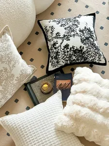 Detail showing plush chenille cushion covers with waffle texture and botanical patterns