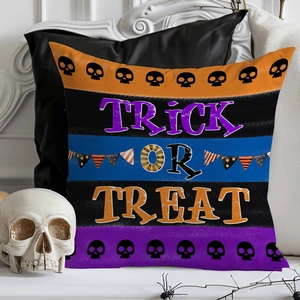 Detail of Trick or Treat Halloween pillow cover with stripes and skull patterns on sofa