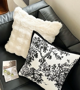 Detail of luxury white faux fur and black tree pattern chenille decorative pillows