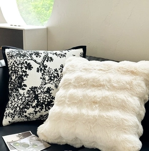 Close-up of luxury chenille and black-white botanical print decorative pillow covers