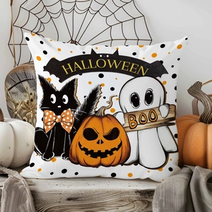 Macro detail of linen Halloween pillow cover with ghost, black cat, and bat banner print