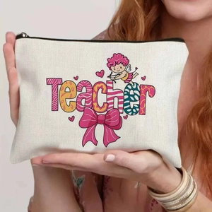 Close-up of the teacher-themed canvas cosmetic bag held by hand to show portable size