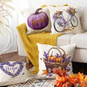 Autumn throw pillow covers set with purple pumpkins and harvest theme on beige sofa