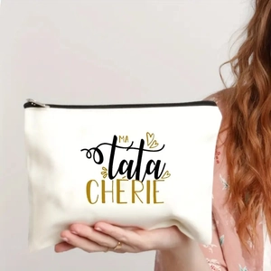 Close-up of a white canvas makeup bag featuring gold heart and MA tata CHÉRIE print