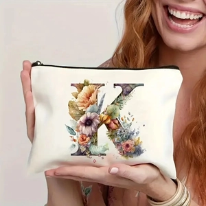 Detail of creative floral letter K printed on a cream canvas makeup organizer bag