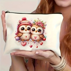 Detail of white makeup bag with cartoon owls and pink hearts held by a model