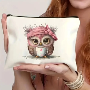 Detail of owl canvas pouch with pink bow and coffee cup print held by hand