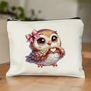 Cute owl pattern white canvas cosmetic bag with zipper on a wooden desk background