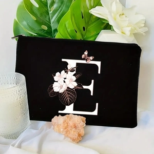Floral letter E makeup bag in black canvas with elegant botanical print and zipper