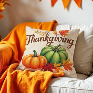Detail of Thanksgiving pillow cover with pumpkin and maple leaf patterns on sofa