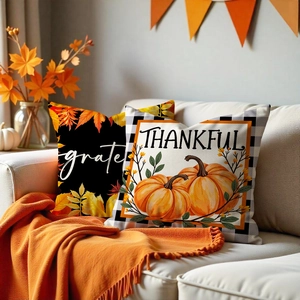 Detail of Thanksgiving cushion covers with grateful text and pumpkin maple leaf prints