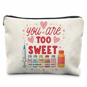 Detail view of canvas nurse pouch showing colorful insulin bottles and text print