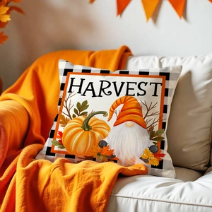 Detail of harvest pillow case with pumpkin gnome on sofa with orange blanket
