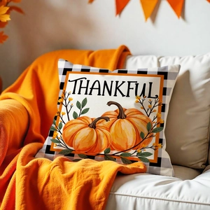Detailed view of Thankful pumpkin pillow cover with black and white checkered borders