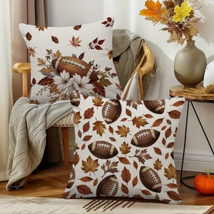 Vintage fall maple leaves and football throw pillow covers on a cozy wooden armchair