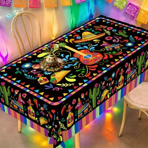 Detailed view of Mexican Fiesta tablecloth with guitar and cactus motifs on black fabric