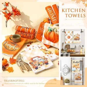 Macro shot of Thanksgiving kitchen towels featuring pumpkin prints and autumn maple leaf patterns