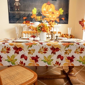 Detailed view of autumn maple leaf pattern tablecloth for Thanksgiving dining room decor
