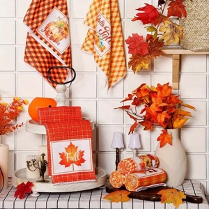 Detail of microfiber kitchen towels featuring autumn pumpkin and maple leaf patterns