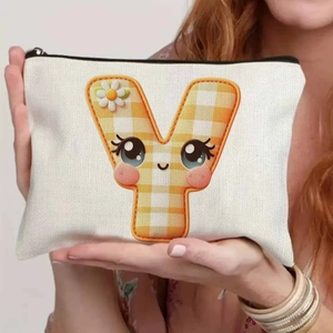 Close-up of canvas pouch featuring a cartoon letter Y with orange checkered pattern
