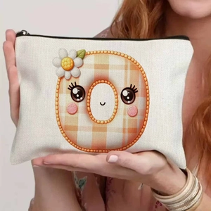 Close-up of beige canvas pouch with orange checkered cartoon face and white daisy