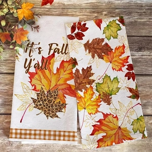 Close-up of microfiber dish towels with Fall Y'all lettering and maple leaf patterns