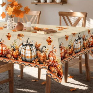Detailed close-up of autumn tablecloth showing pumpkin and maple leaf patterns
