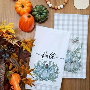 Detailed view of fall microfiber kitchen towels with pumpkin and leaf prints and wood decor