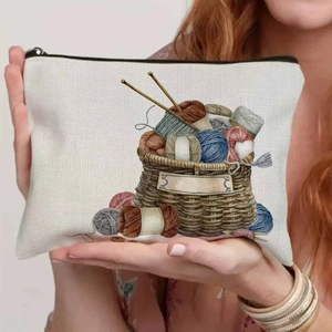 Close-up of durable canvas pouch showing colorful knitting basket print and zipper