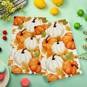 Detail of two-piece microfiber kitchen towels featuring pumpkin and maple leaf prints