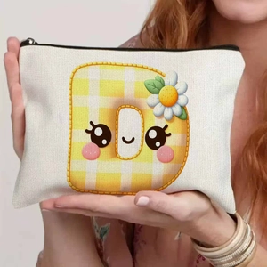 Cute canvas storage pouch with yellow plaid letter D and daisy detail held by model
