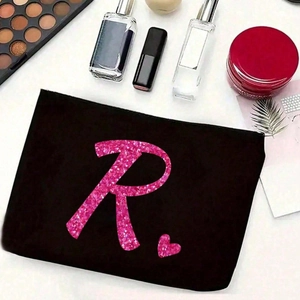 Schwarze Make-up Tasche aus Canvas mit rosa Glitzer Buchstabe R und Kosmetik