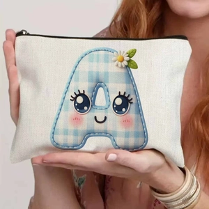 Detailed view of canvas makeup pouch with cute blue checkered letter A and daisy design