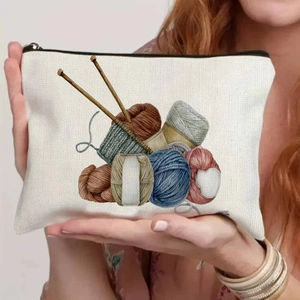 Close-up of canvas makeup bag featuring colorful yarn ball prints and black zipper detail