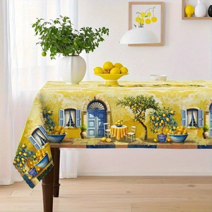 Detailed view of Mediterranean tablecloth with lemon and blue arch patterns on wood table