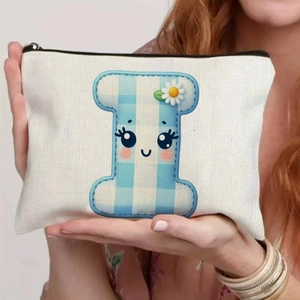 Canvas makeup bag with blue checkered letter I and cartoon smile in hand-held display