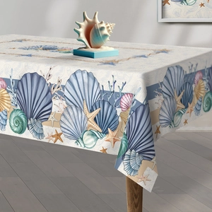 Detail of nautical tablecloth featuring blue seashells and starfish on linen fabric