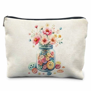 Close-up of linen sewing kit bag with colorful button jar print and top zipper closure