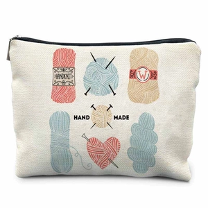 Detailed close-up of sewing storage bag with handknit wool ball prints and linen texture