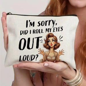 Close-up of cream canvas pouch featuring vintage pop-art print and a black zipper closure