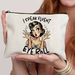 Detailed close-up of ivory canvas makeup bag with retro girl eye roll print and zipper
