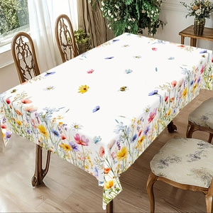 Detail of vibrant floral and butterfly patterns on a white rustic summer tablecloth