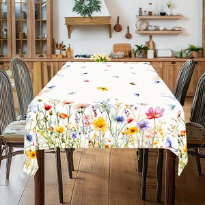 Close-up of floral border pattern with sunflowers and butterflies on white table cloth