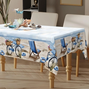 Detail of beach themed tablecloth with vintage bicycle and sand chair patterns
