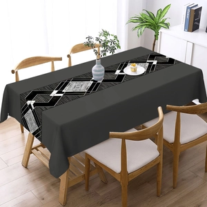 Detail of grey tablecloth featuring black and white geometric diamond patterns