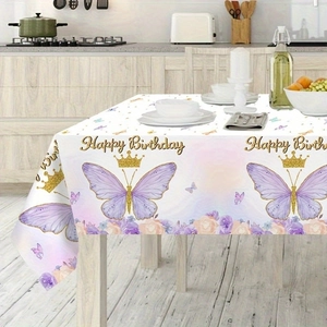 Detail view of Happy Birthday tablecloth featuring purple butterflies and golden crowns